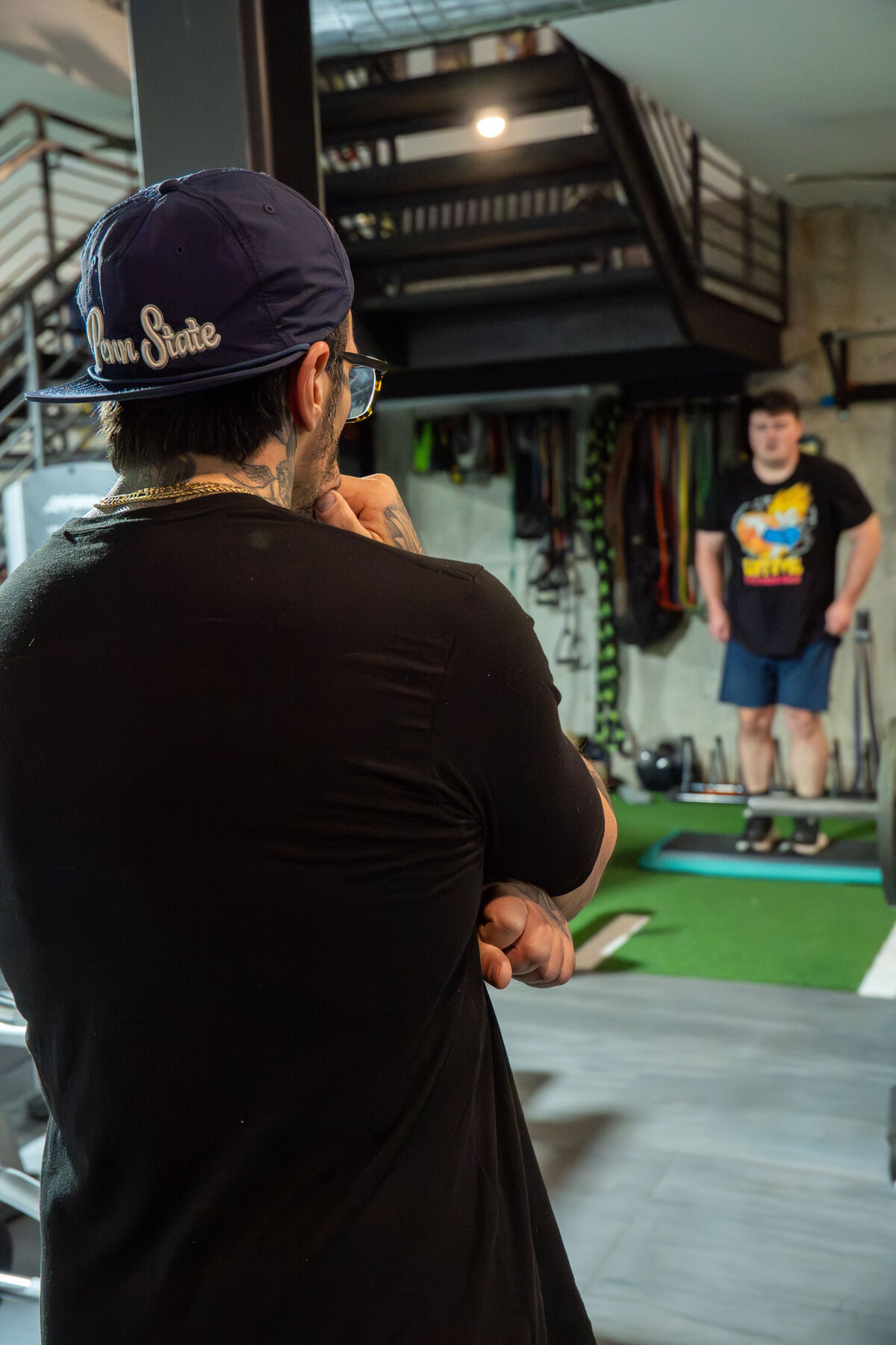 Coach adjusting a member's setup