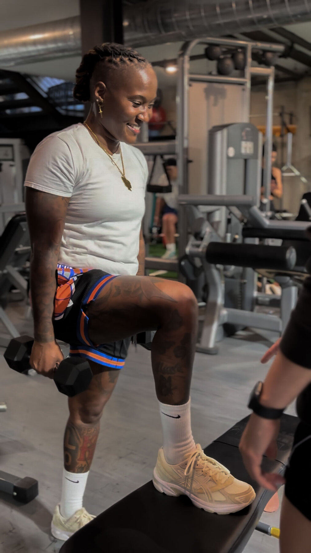 Members training side-by-side on leg extension