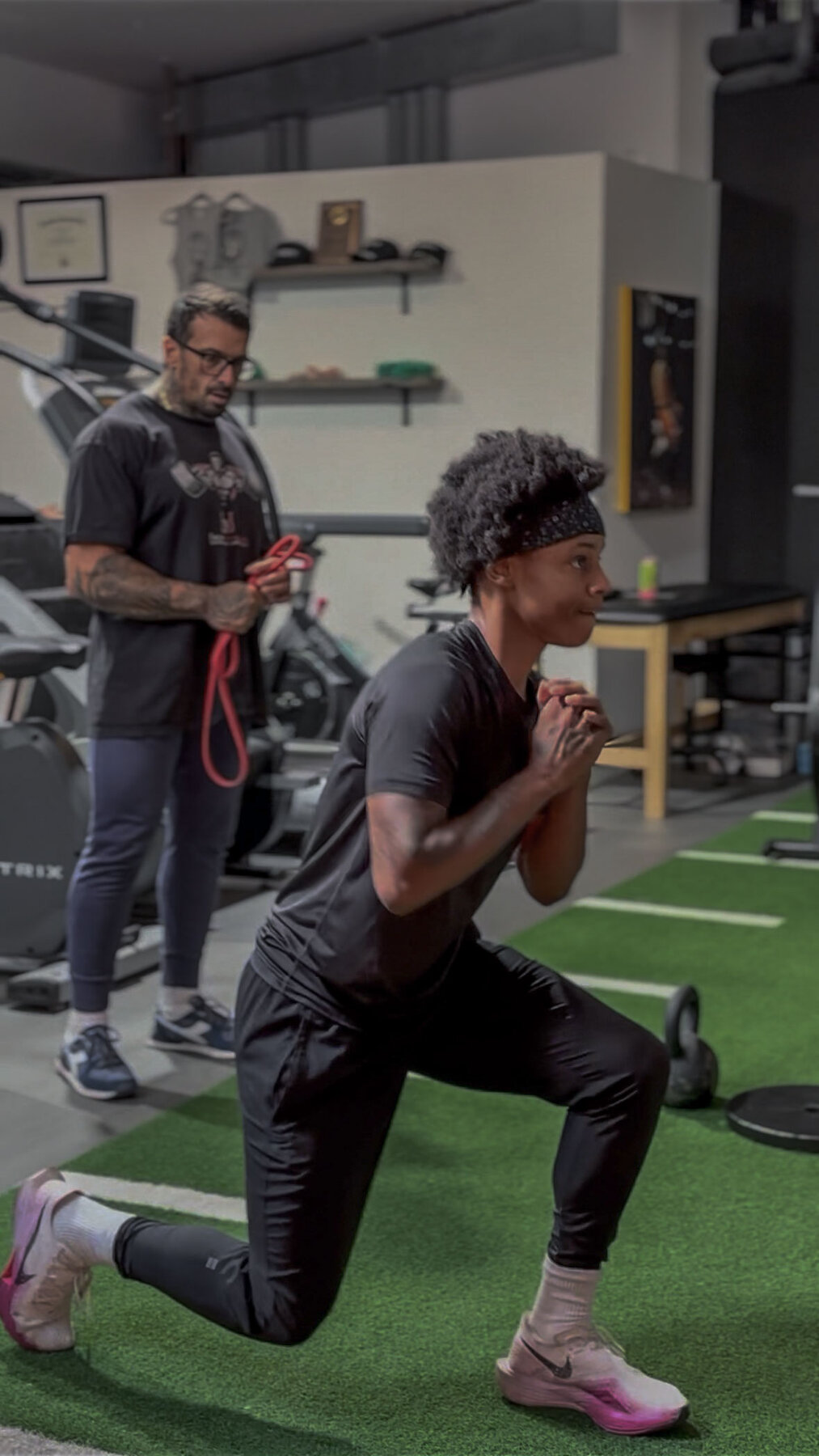 Coached plank-with-sliders work on turf
